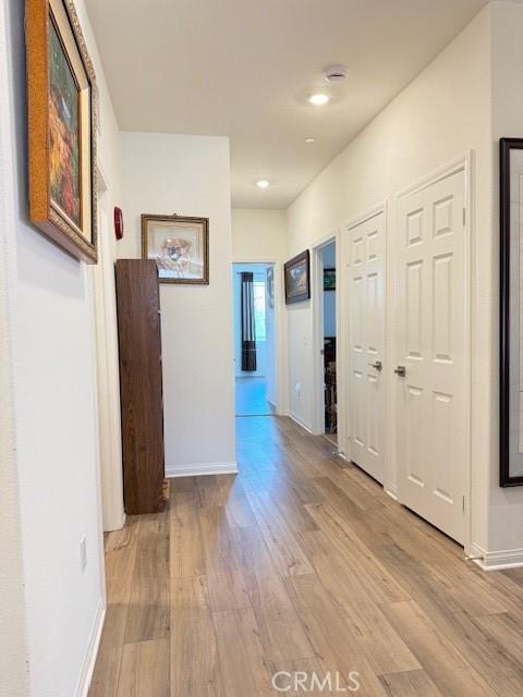 7676 Nectarsweet Dr, Riverside, CA 92507 - corridor featuring light wood-style floors and recessed lighting