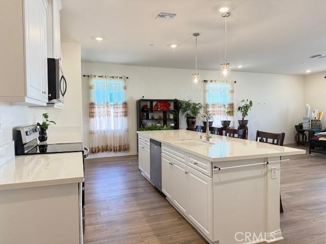 7676 Nectarsweet Dr, Riverside, CA 92507 - kitchen with stainless steel appliances, white cabinetry, light wood-type flooring, and recessed lighting