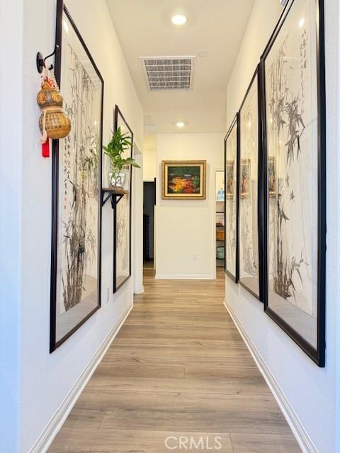 7676 Nectarsweet Dr, Riverside, CA 92507 - corridor featuring light wood-style flooring and baseboards