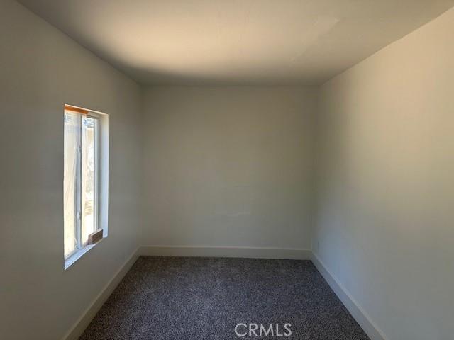 2466 W Wilson St, Banning, CA 92220 - spare room featuring healthy amount of natural light and dark colored carpet