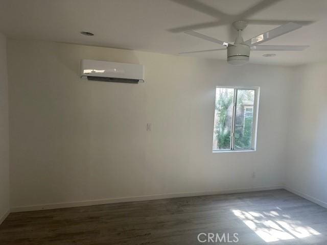 2466 W Wilson St, Banning, CA 92220 - empty room with a wall mounted AC, a ceiling fan, and wood finished floors