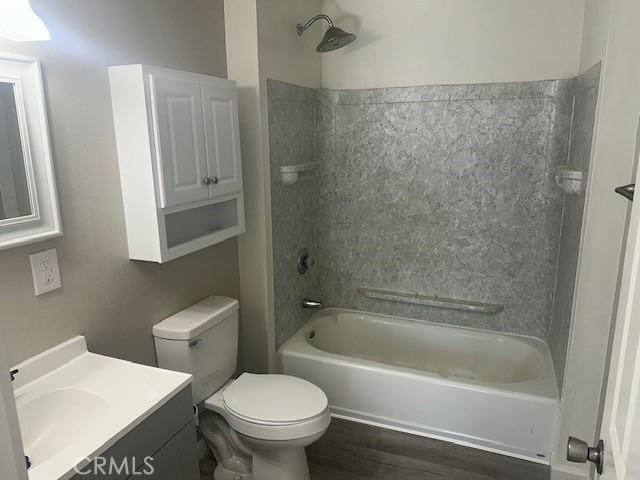 2466 W Wilson St, Banning, CA 92220 - full bathroom featuring vanity, shower / washtub combination, and wood finished floors