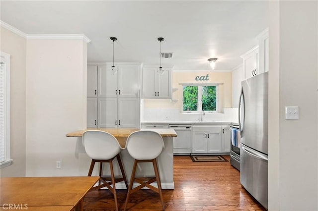 4514 Cedros Ave, Sherman Oaks, CA 91403 - kitchen featuring white dishwasher, freestanding refrigerator, a breakfast bar area, ornamental molding, and wood finished floors