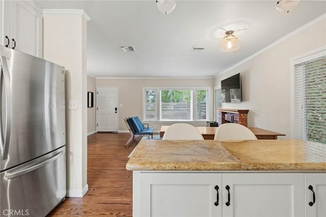 4514 Cedros Ave, Sherman Oaks, CA 91403 - kitchen featuring freestanding refrigerator, ornamental molding, wood finished floors, and white cabinetry
