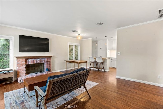 4514 Cedros Ave, Sherman Oaks, CA 91403 - living room featuring ornamental molding, plenty of natural light, wood finished floors, and a brick fireplace