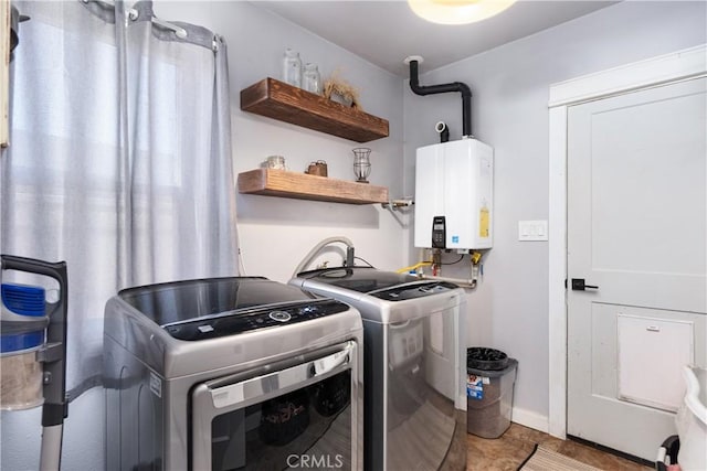 402 E St, Orland, CA 95963 - laundry room featuring tankless water heater, washer and dryer, and tile patterned floors
