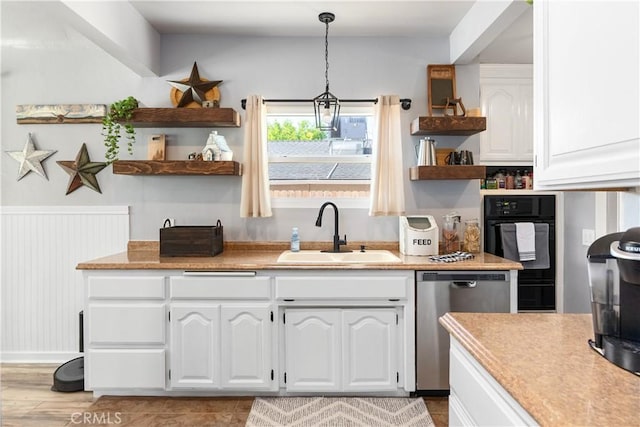 402 E St, Orland, CA 95963 - kitchen featuring open shelves, stainless steel dishwasher, white cabinetry, light countertops, and pendant lighting