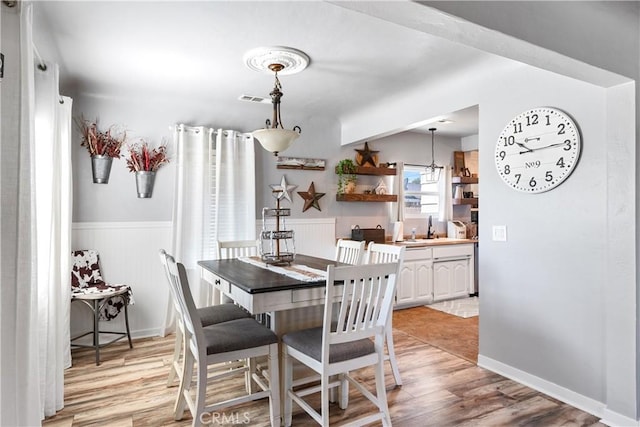402 E St, Orland, CA 95963 - dining room featuring light wood-style flooring and wainscoting