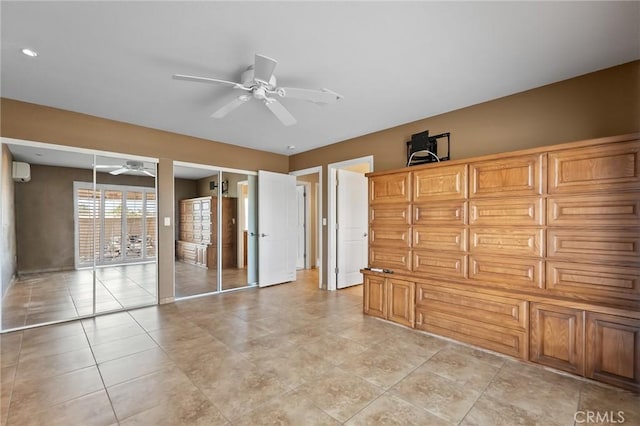 58960 Delano Trl, Yucca Valley, CA 92284 - unfurnished room with ceiling fan, an AC wall unit, and light tile patterned floors