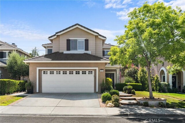 27811 Bloomfield Ct, Valencia, CA 91354 - traditional-style house featuring concrete driveway, a tiled roof, stucco siding, and a garage