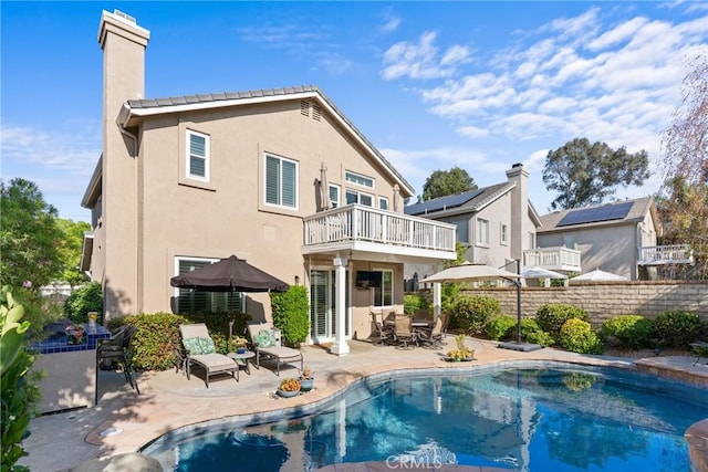 27811 Bloomfield Ct, Valencia, CA 91354 - rear view of property with a balcony, a chimney, a patio, and stucco siding