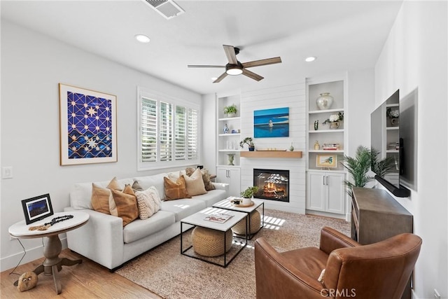 27811 Bloomfield Ct, Valencia, CA 91354 - living room with ceiling fan, a large fireplace, built in shelves, wood finished floors, and recessed lighting