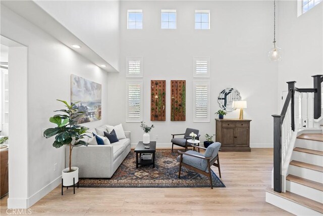 27811 Bloomfield Ct, Valencia, CA 91354 - living room featuring a high ceiling, stairway, healthy amount of natural light, light wood-style floors, and recessed lighting