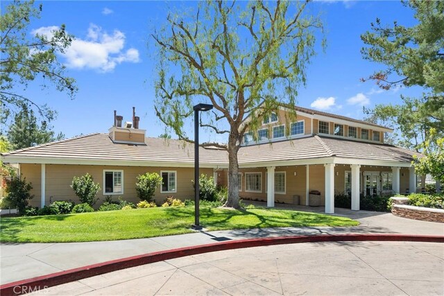 27811 Bloomfield Ct, Valencia, CA 91354 - view of front of house featuring a tiled roof, a chimney, and a front lawn
