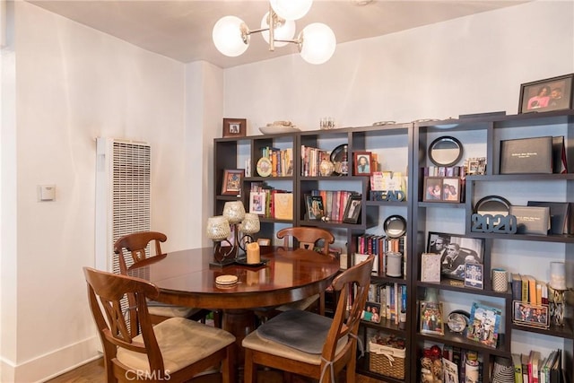 1517 E 1st St, Long Beach, CA 90802 - dining area with a chandelier, wood finished floors, and a heating unit