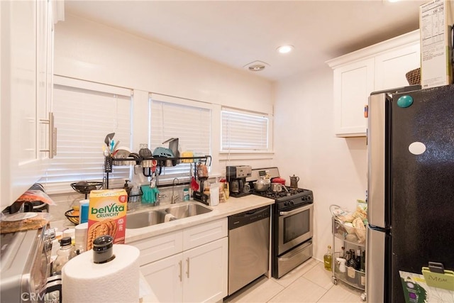 1517 E 1st St, Long Beach, CA 90802 - kitchen featuring appliances with stainless steel finishes, white cabinets, light tile patterned flooring, light countertops, and recessed lighting