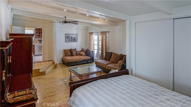 6418 Whitman Ave, Van Nuys, CA 91406 - bedroom featuring light wood-style flooring, beam ceiling, track lighting, a closet, and a ceiling fan