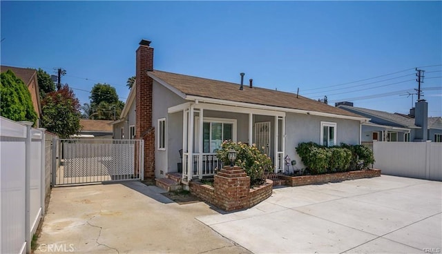 6418 Whitman Ave, Van Nuys, CA 91406 - bungalow featuring stucco siding, a gate, a chimney, and covered porch