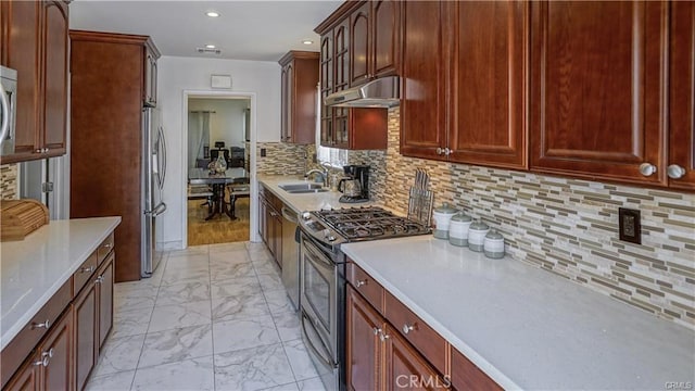 6418 Whitman Ave, Van Nuys, CA 91406 - kitchen featuring appliances with stainless steel finishes, light marble finish flooring, under cabinet range hood, light countertops, and recessed lighting