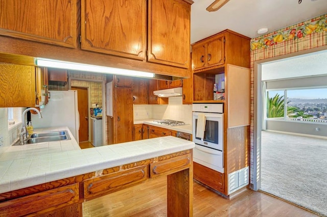 1106 Dawnridge Ave, El Cajon, CA 92021 - kitchen with oven, a warming drawer, tile counters, stainless steel gas stovetop, and under cabinet range hood