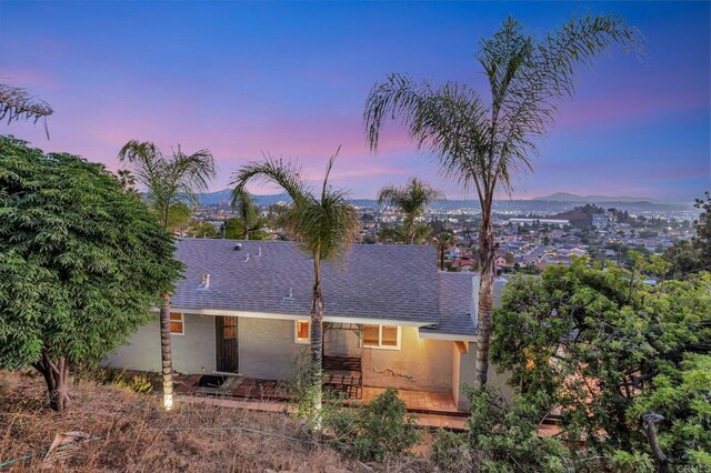 1106 Dawnridge Ave, El Cajon, CA 92021 - rear view of house featuring a shingled roof, stucco siding, and a mountain view