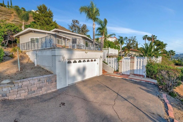 1106 Dawnridge Ave, El Cajon, CA 92021 - view of front of home featuring asphalt driveway, an attached garage, and stucco siding