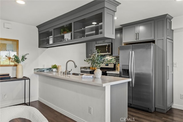 2700 Cahuenga Blvd E Unit 3104, Los Angeles, CA 90068 - kitchen with stainless steel appliances, a peninsula, gray cabinets, light countertops, and dark wood-style floors