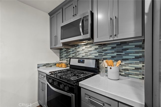 2700 Cahuenga Blvd E Unit 3104, Los Angeles, CA 90068 - kitchen with appliances with stainless steel finishes, gray cabinetry, tasteful backsplash, and light countertops