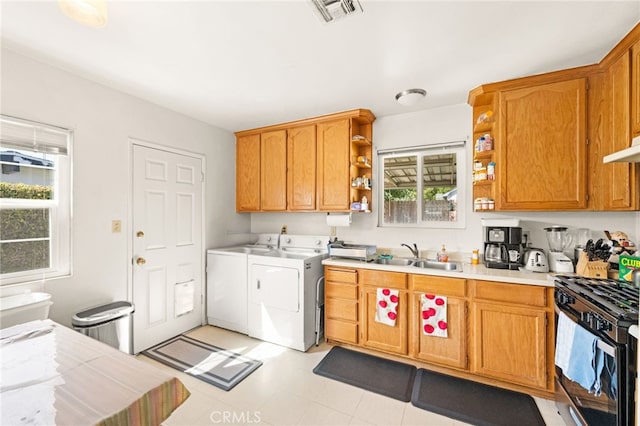 3551 Brynhurst Dr, Riverside, CA 92504 - kitchen with washer and clothes dryer, open shelves, black gas range, light countertops, and range hood