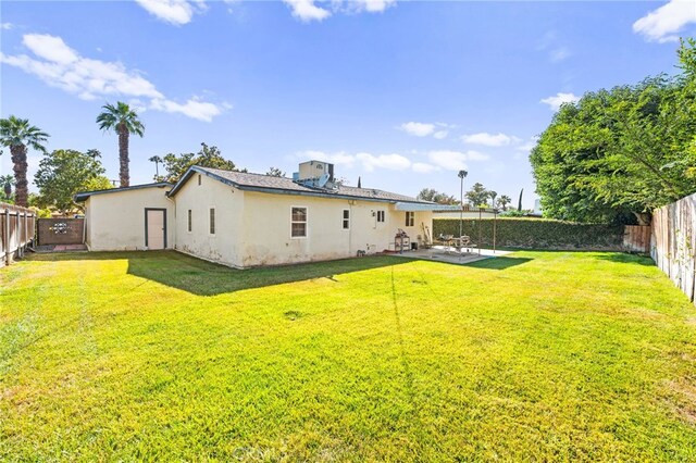 3551 Brynhurst Dr, Riverside, CA 92504 - back of house featuring a patio, stucco siding, and a fenced backyard