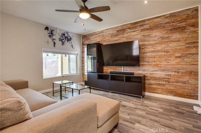 10105 S Main St, Los Angeles, CA 90003 - living area with wooden walls, an accent wall, ceiling fan, and wood finished floors