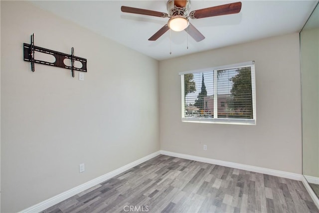 10105 S Main St, Los Angeles, CA 90003 - spare room featuring wood finished floors and a ceiling fan