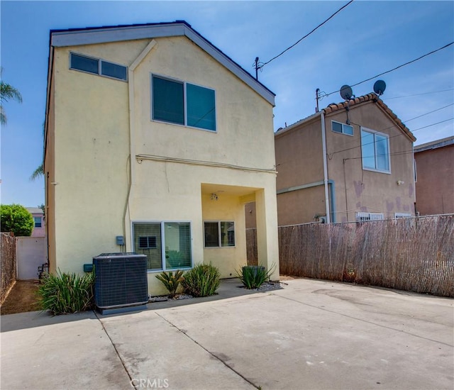 10105 S Main St, Los Angeles, CA 90003 - rear view of property with stucco siding and a patio