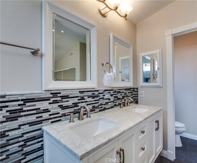 10105 S Main St, Los Angeles, CA 90003 - full bathroom featuring lofted ceiling, double vanity, tile patterned floors, and decorative backsplash