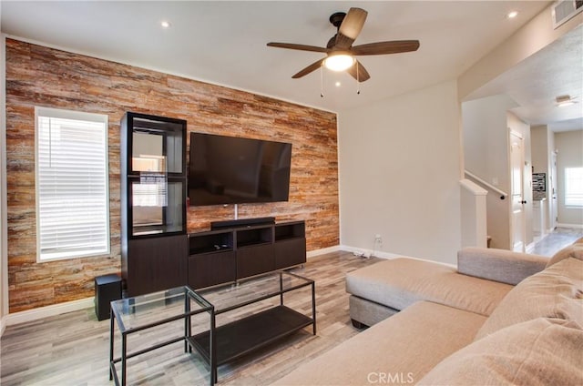 10105 S Main St, Los Angeles, CA 90003 - living area with light wood finished floors, ceiling fan, wood walls, an accent wall, and recessed lighting