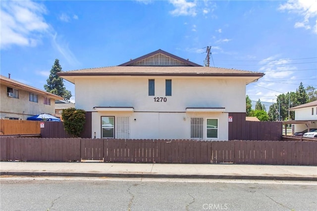 1270 W 9th St, Corona, CA 92882 - view of front of house with stucco siding and a fenced front yard