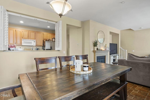 3366 Shadetree Way, Camarillo, CA 93012 - dining room with a fireplace, recessed lighting, and dark stone finish flooring