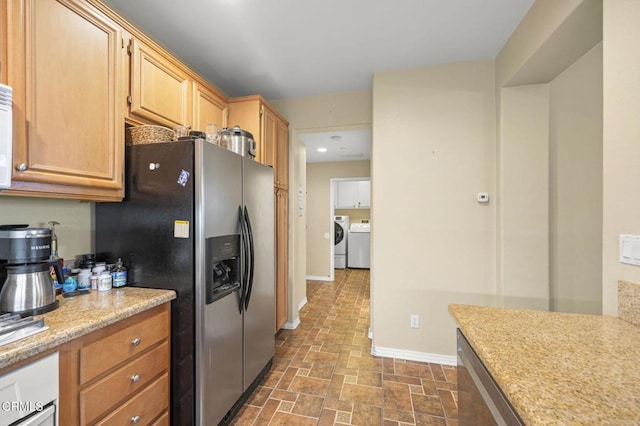 3366 Shadetree Way, Camarillo, CA 93012 - kitchen with stainless steel refrigerator with ice dispenser, washing machine and clothes dryer, stone finish flooring, and light brown cabinets