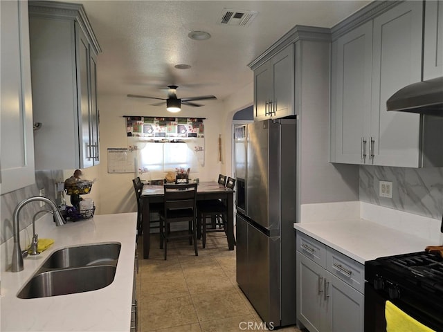 15768 Amar Rd, La Puente, CA 91744 - kitchen with stainless steel fridge, gray cabinets, tasteful backsplash, and light countertops