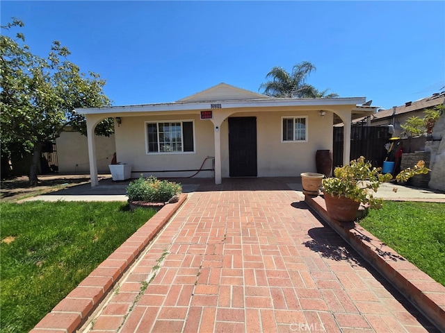 15768 Amar Rd, La Puente, CA 91744 - single story home featuring stucco siding, a front lawn, and a patio area