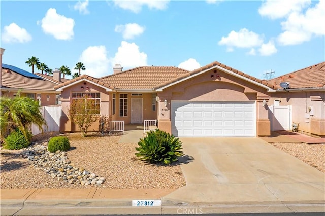 27812 Ruggie Rd, Menifee, CA 92585 - mediterranean / spanish house featuring stucco siding, an attached garage, a tiled roof, concrete driveway, and a chimney