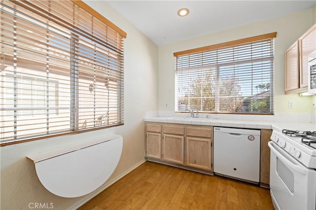 27812 Ruggie Rd, Menifee, CA 92585 - kitchen with white appliances, plenty of natural light, light wood-style floors, tile countertops, and recessed lighting