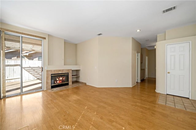 27812 Ruggie Rd, Menifee, CA 92585 - unfurnished living room with light wood finished floors, a fireplace, and recessed lighting