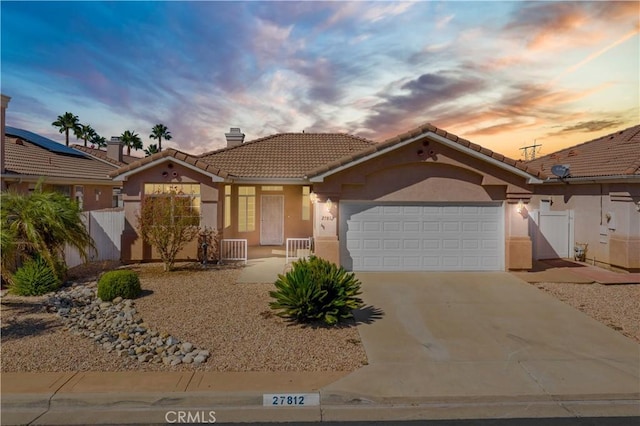 27812 Ruggie Rd, Menifee, CA 92585 - mediterranean / spanish house with a tiled roof, stucco siding, concrete driveway, a chimney, and a garage