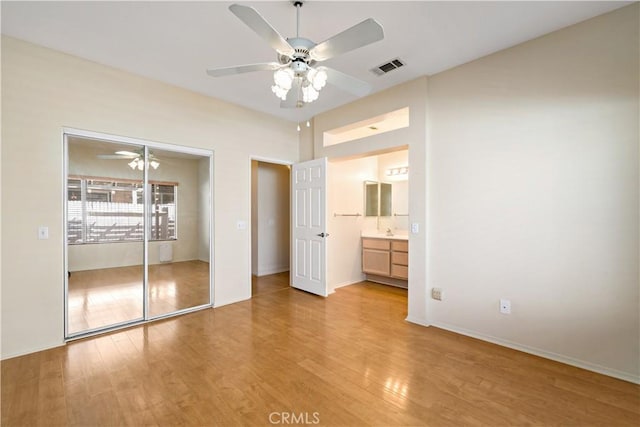 27812 Ruggie Rd, Menifee, CA 92585 - unfurnished bedroom featuring light wood-style flooring, a closet, a ceiling fan, and ensuite bath