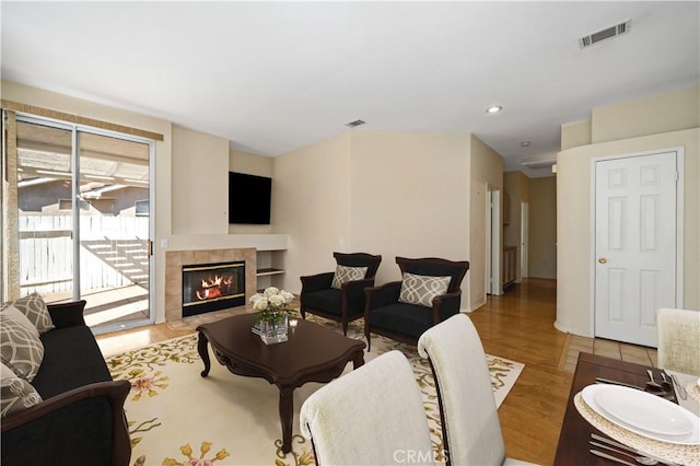 27812 Ruggie Rd, Menifee, CA 92585 - living room with wood finished floors, a tiled fireplace, and recessed lighting