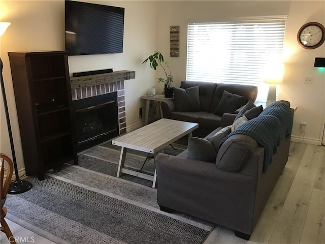 9144 Oakleaf Ct, Hesperia, CA 92344 - living area with wood finished floors and a brick fireplace