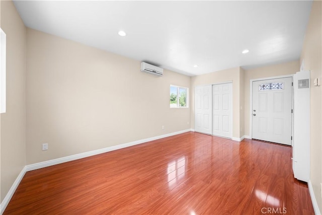 2047 Delford Ave, Duarte, CA 91010 - unfurnished living room with a wall mounted air conditioner, wood finished floors, and recessed lighting
