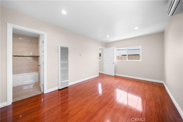 2047 Delford Ave, Duarte, CA 91010 - unfurnished bedroom featuring a heating unit, a wall unit AC, wood finished floors, and recessed lighting