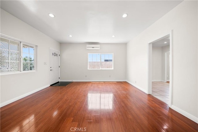 2047 Delford Ave, Duarte, CA 91010 - unfurnished room with a wall mounted air conditioner, plenty of natural light, wood-type flooring, and recessed lighting